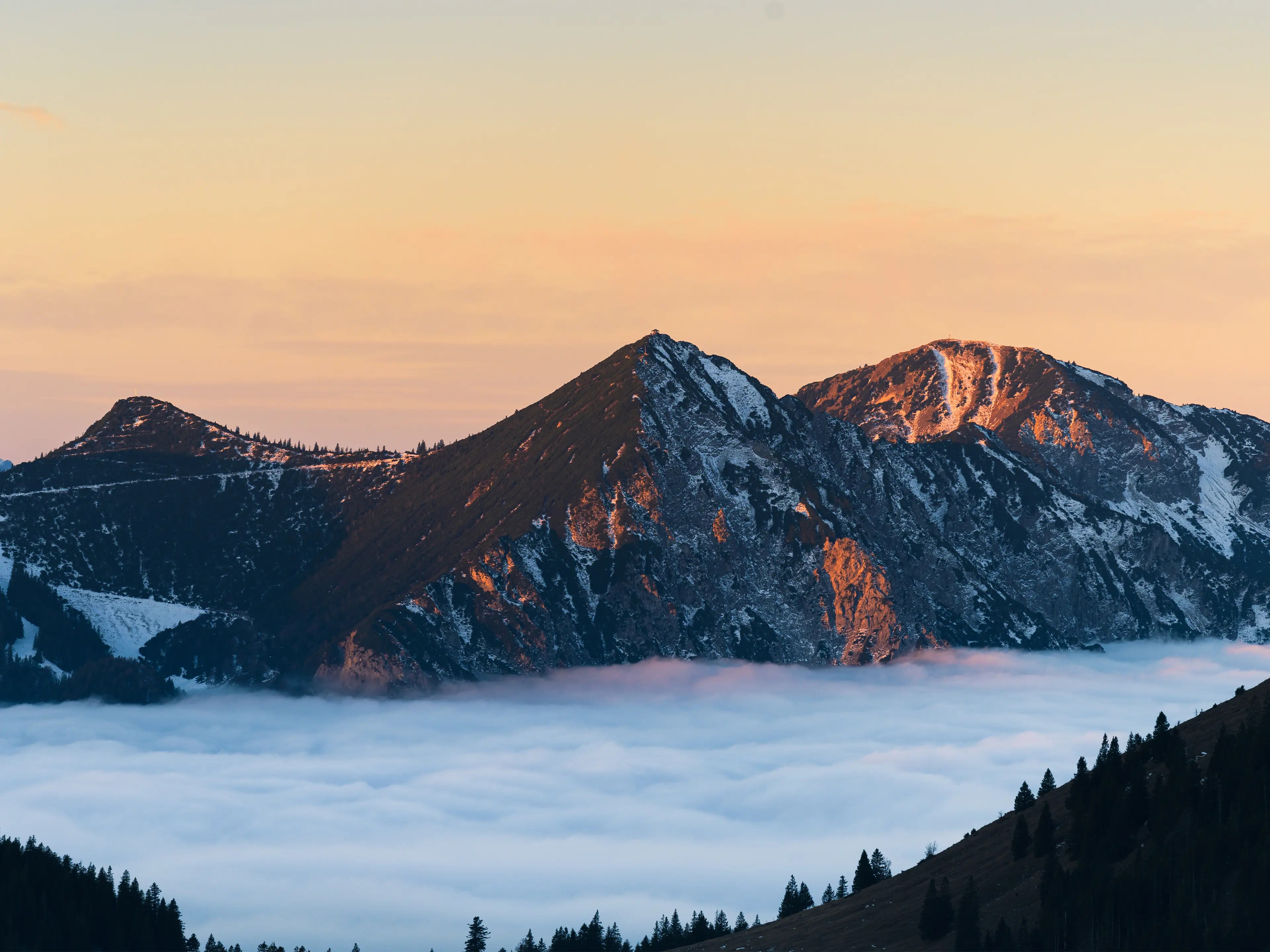 Der Blick zum Herzogstand mit einer leichten Schneedecke zum Sonnenaufgang.