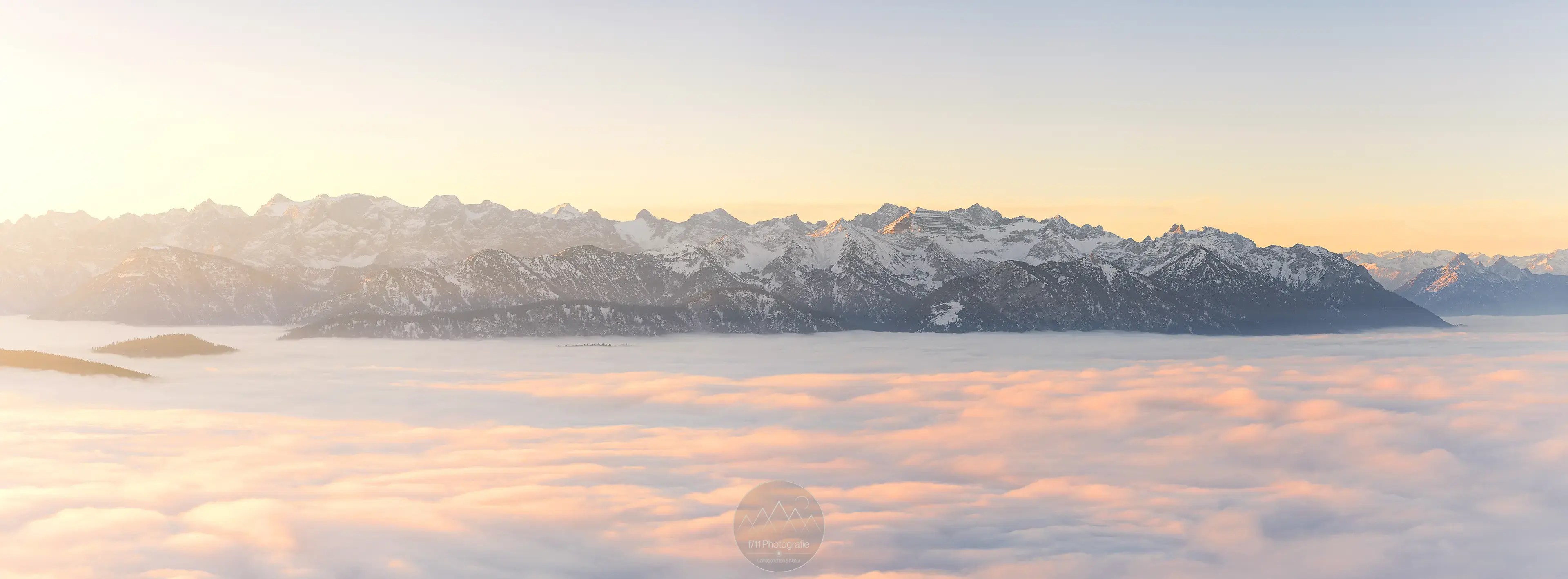 Das gesamte Karwendelgebirge ragt aus einer dichten Nebeldecke heraus.